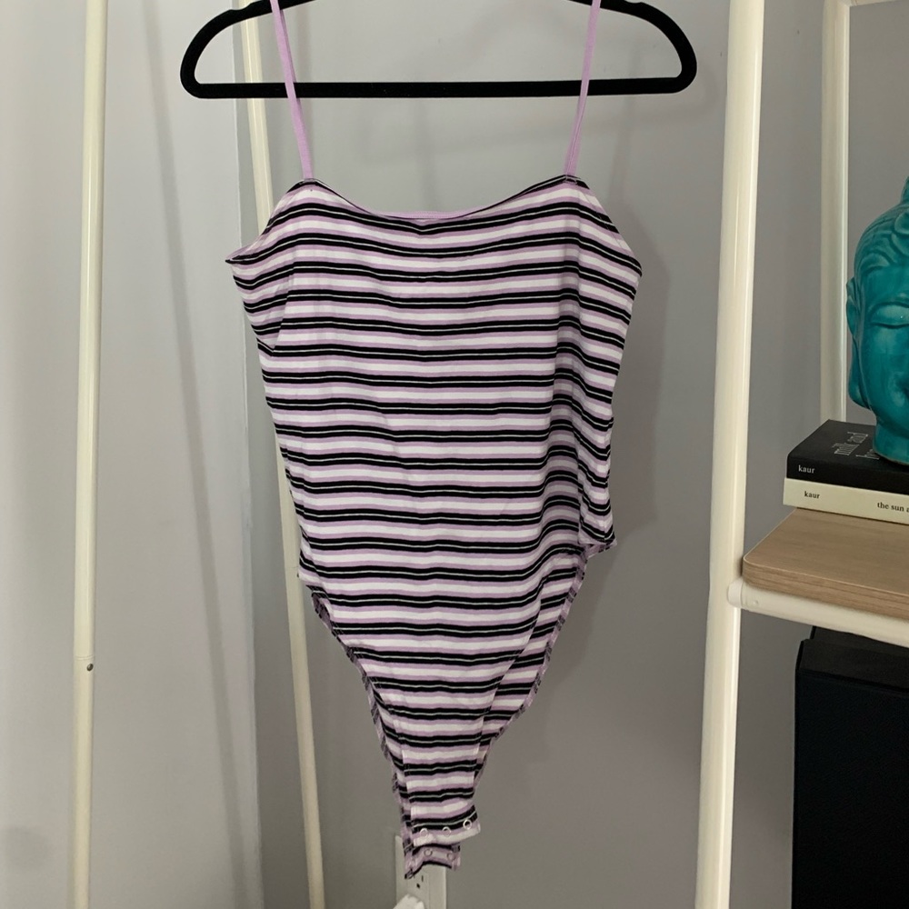 Purple black and white body suit.